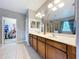 This bathroom features dual sinks, vanity, and a door to a walk-in closet at 3544 Brook Crossing Dr, Brandon, FL 33511