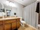 Bathroom with a sink vanity and tile flooring, accompanied by a shower with gray curtain at 3544 Brook Crossing Dr, Brandon, FL 33511