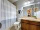 This bathroom features a large mirror, a vanity with storage, and a shower with a curtain at 3544 Brook Crossing Dr, Brandon, FL 33511