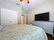 Bedroom with wood floors, ceiling fan, and a TV atop a dresser at 3544 Brook Crossing Dr, Brandon, FL 33511