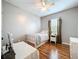 Well-lit bedroom with wood floors, bed, nightstand, and curtains at 3544 Brook Crossing Dr, Brandon, FL 33511