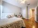 This bedroom features hardwood floors, a ceiling fan, and neutral paint at 3544 Brook Crossing Dr, Brandon, FL 33511