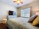 Cozy bedroom featuring a comfortable bed, dresser with a TV, and a ceiling fan at 3544 Brook Crossing Dr, Brandon, FL 33511