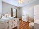 This bedroom features wood floors, a white ceiling fan, and a large window at 3544 Brook Crossing Dr, Brandon, FL 33511