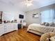 This bedroom features hardwood floors, a ceiling fan, desk and dresser at 3544 Brook Crossing Dr, Brandon, FL 33511