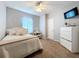 Well-lit bedroom with carpet, bed, dresser with TV, ceiling fan, and white trim at 3544 Brook Crossing Dr, Brandon, FL 33511