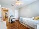Well-lit bedroom with wood floors, featuring a white bed and vanity setup at 3544 Brook Crossing Dr, Brandon, FL 33511