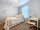 Well-lit bedroom with carpet, bed, vanity desk, mirror, and white trim at 3544 Brook Crossing Dr, Brandon, FL 33511