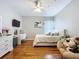 This bedroom features hardwood floors, a ceiling fan, and desk at 3544 Brook Crossing Dr, Brandon, FL 33511