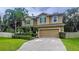 Beautiful two-story home with green shutters, a manicured lawn, and a spacious driveway at 3544 Brook Crossing Dr, Brandon, FL 33511