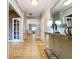 Inviting hallway with tile floors, a decorative table and a view of the living spaces at 3544 Brook Crossing Dr, Brandon, FL 33511