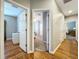 Hallway view showcasing wood floors and multiple doorways leading to bedrooms at 3544 Brook Crossing Dr, Brandon, FL 33511