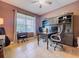 Shot of home office with dark brown walls, two desks and chairs, and built in shelving at 3544 Brook Crossing Dr, Brandon, FL 33511