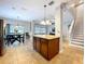 Open layout with kitchen island, dining area, and staircase access at 3544 Brook Crossing Dr, Brandon, FL 33511