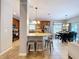 Open kitchen and dining area with stainless appliances, bar seating, and view to backyard at 3544 Brook Crossing Dr, Brandon, FL 33511