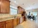 Spacious kitchen featuring granite countertops, tile backsplash, stainless appliances, and dining area at 3544 Brook Crossing Dr, Brandon, FL 33511