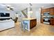 Kitchen and bar with seating with open concept to living room and stairs in the background at 3544 Brook Crossing Dr, Brandon, FL 33511