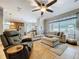 Spacious living room with a ceiling fan, large window and plush seating with natural light at 3544 Brook Crossing Dr, Brandon, FL 33511