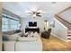 Open-concept living room with large window, plush seating, and sleek entertainment center at 3544 Brook Crossing Dr, Brandon, FL 33511