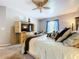 Cozy main bedroom featuring a large bed, built-in media center, and a window with curtains at 3544 Brook Crossing Dr, Brandon, FL 33511