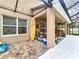 Outdoor patio with a surfboard decoration, comfortable seating, and an adjacent bar area at 3544 Brook Crossing Dr, Brandon, FL 33511