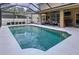 Refreshing screened-in pool with ample space for swimming and a covered patio area with bar seating at 3544 Brook Crossing Dr, Brandon, FL 33511
