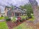 Enclosed pool with tropical landscaping creates a backyard oasis for relaxation and recreation at 3544 Brook Crossing Dr, Brandon, FL 33511