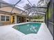 Backyard with a screened-in pool and covered patio, perfect for outdoor entertaining and relaxation at 3544 Brook Crossing Dr, Brandon, FL 33511