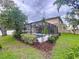 A gorgeous screened-in pool is surrounded by lush landscaping in this backyard at 3544 Brook Crossing Dr, Brandon, FL 33511
