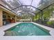 Sparkling in-ground pool with a screened enclosure and view of the fenced-in backyard at 3544 Brook Crossing Dr, Brandon, FL 33511