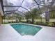 Inviting screened-in pool offers a serene retreat with lush landscaping for added privacy at 3544 Brook Crossing Dr, Brandon, FL 33511