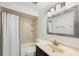 Bathroom showcasing a shower-tub combo, patterned shower curtain, and vanity at 3705 Simpson Ct, Palm Harbor, FL 34684