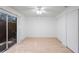 Bright bedroom featuring light wood floors, ceiling fan, sliding glass door, and closet at 3705 Simpson Ct, Palm Harbor, FL 34684