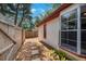 Property exterior view featuring stucco siding, walkway, and a privacy fence at 3705 Simpson Ct, Palm Harbor, FL 34684
