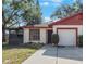 Charming single-story home with a manicured lawn and a screened-in porch, perfect for enjoying the outdoors at 3705 Simpson Ct, Palm Harbor, FL 34684