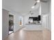 Open-concept living space featuring modern kitchen with black cabinets and stainless steel appliances at 3705 Simpson Ct, Palm Harbor, FL 34684