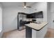 Modern kitchen featuring stainless steel appliances, black cabinetry and a bright breakfast bar with ample space at 3705 Simpson Ct, Palm Harbor, FL 34684