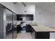Recently remodeled kitchen featuring stainless steel appliances, black cabinets and a bright breakfast bar at 3705 Simpson Ct, Palm Harbor, FL 34684
