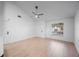 Bright and airy living room with high ceilings, light wood floors, and large window at 3705 Simpson Ct, Palm Harbor, FL 34684