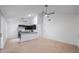Inviting open-concept living space with sleek black kitchen, stainless steel appliances and light wood floors at 3705 Simpson Ct, Palm Harbor, FL 34684