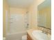 A bright bathroom features a tub-shower combination and a sleek vanity with integrated sink at 37712 Aaralyn Rd, Zephyrhills, FL 33542