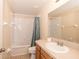 A well-lit bathroom offers a combination of bathtub and shower with sleek, neutral-toned fixtures at 37712 Aaralyn Rd, Zephyrhills, FL 33542