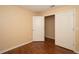 This bedroom has wood floors, a light colored wall, and two white doors at 37712 Aaralyn Rd, Zephyrhills, FL 33542
