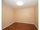 Cozy bedroom featuring wood floors, neutral walls, a standard closet, and natural light at 37712 Aaralyn Rd, Zephyrhills, FL 33542