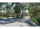 Welcoming gated community entrance surrounded by mature trees and landscaping at 37712 Aaralyn Rd, Zephyrhills, FL 33542