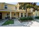 Inviting townhome exterior featuring a covered porch, manicured landscaping, and classic architectural details at 37712 Aaralyn Rd, Zephyrhills, FL 33542