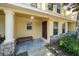 Charming townhome featuring a covered porch and manicured landscaping at 37712 Aaralyn Rd, Zephyrhills, FL 33542