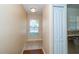 Hallway with wood flooring and tile, window, and closet at 37712 Aaralyn Rd, Zephyrhills, FL 33542
