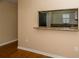 View of the kitchen pass-through featuring granite counters and wood cabinets at 37712 Aaralyn Rd, Zephyrhills, FL 33542