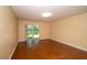 Bright living area with gleaming hardwood floors and sliding glass doors that lead to the patio at 37712 Aaralyn Rd, Zephyrhills, FL 33542